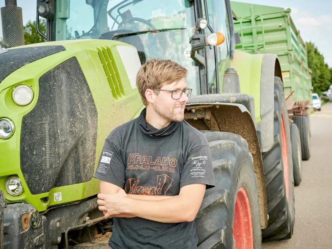 Richard Kauffmann auf dem Hof vor dem Traktor